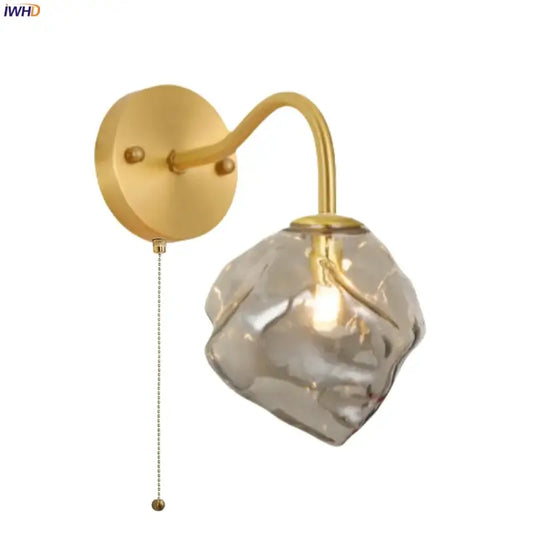 Modern grey glass led wall lamp with gold finish and textured translucent irregular crystal shade for bedroom décor