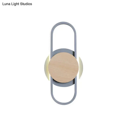 Modern grey and light wood led wall sconce with sleek metal frame natural wood accent and warm bedroom ring light