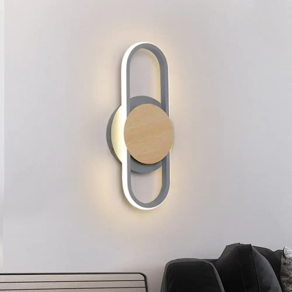 Modern grey and light wood led wall sconce with a sleek circular design featuring an illuminated bedroom ring light