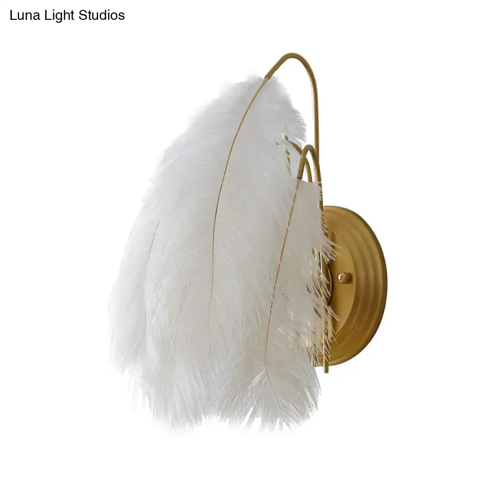 Modern grey and white furry goose feather wall lamp with white feathered sconce and gold-toned metal frame