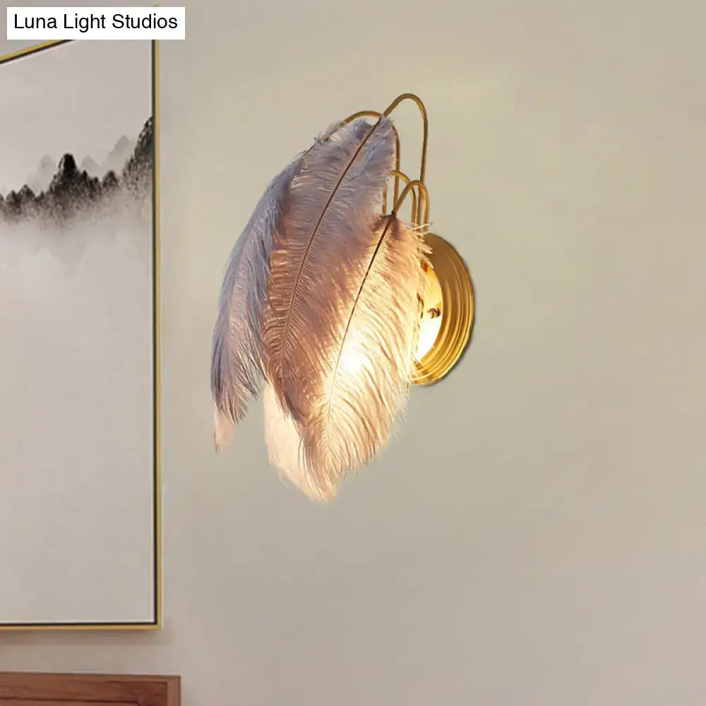 Modern grey and white furry goose feather wall lamp with golden metal base for bedroom use