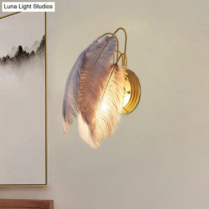 Modern grey and white furry goose feather wall lamp with golden metal base for bedroom use
