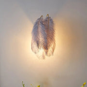 Modern grey and white furry goose feather wall lamp with soft pale gray ostrich feather texture and golden hooks