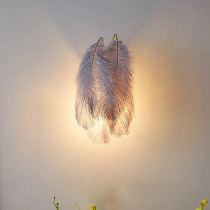 Modern grey and white furry goose feather wall lamp with soft pale gray ostrich feather texture and golden hooks