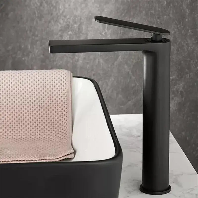 Modern gun gray basin faucet with sleek matte black finish and minimalist waterfall design for bathroom sink by decorbites