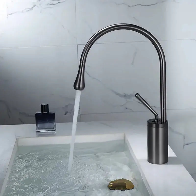 Modern gun grey brass basin faucet with a sleek matte black curved spout and cylindrical base for kitchen use by decorbites