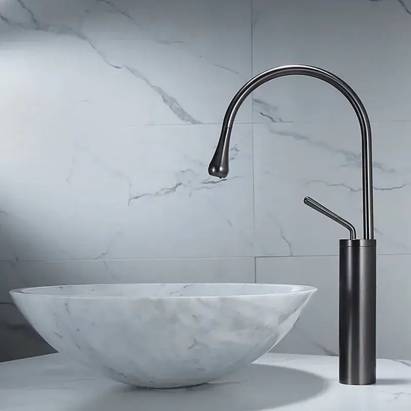 Modern gun grey brass basin faucet with a matte black sleek curved spout and cylindrical base for kitchen use decorbites