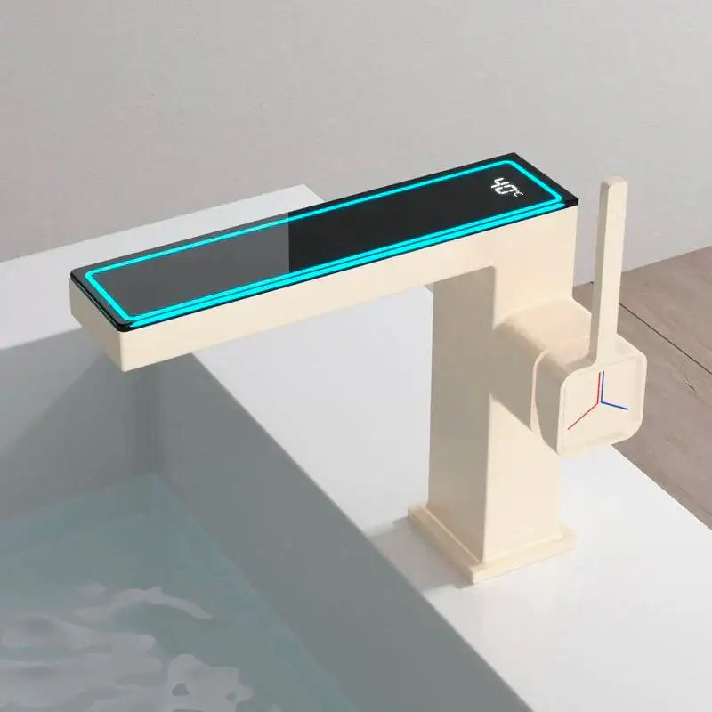 Cream-colored modern basin faucet with gun grey digital display showing temperature in bright blue neon light decorbites gun grey