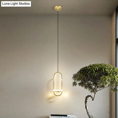 Modern halo ring bedside pendant light with gold-toned minimalist oval frame and warm ambient glow for bedroom use