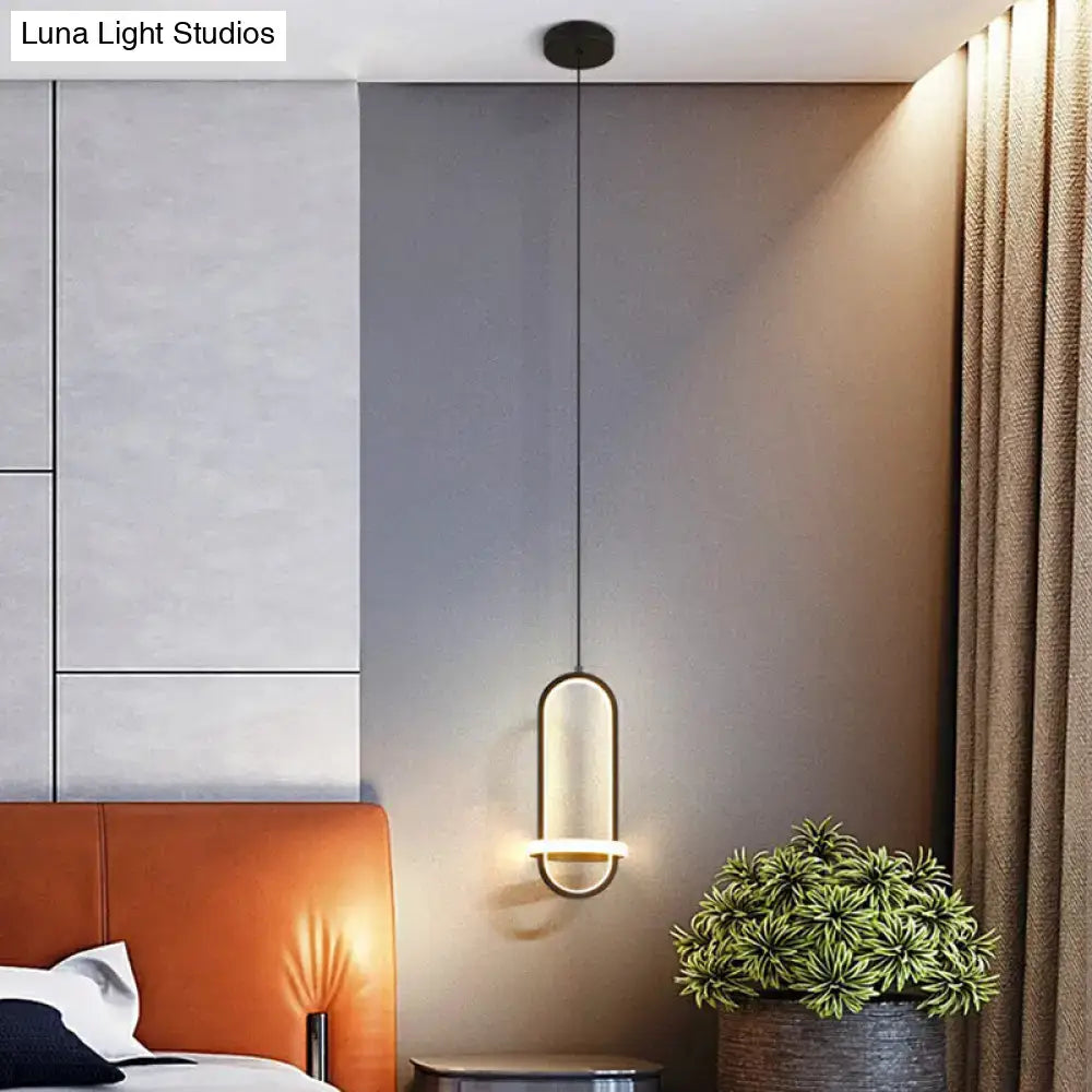Modern halo ring bedside pendant light with sleek elongated oval shape and warm ambient glow for bedroom lighting