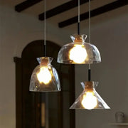 Three modern decorbites clear glass pendant lamps with hammered shades and black metal fixtures for kitchen lighting