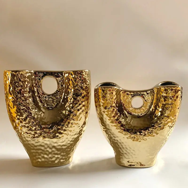 Two modern hammered gold vases with textured ceramic surface and circular openings for living room decorbites gold vase set