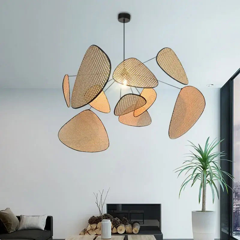 Modern hand made rattan pendant light featuring warm earthy tones and asymmetrical leaf shapes for living room use