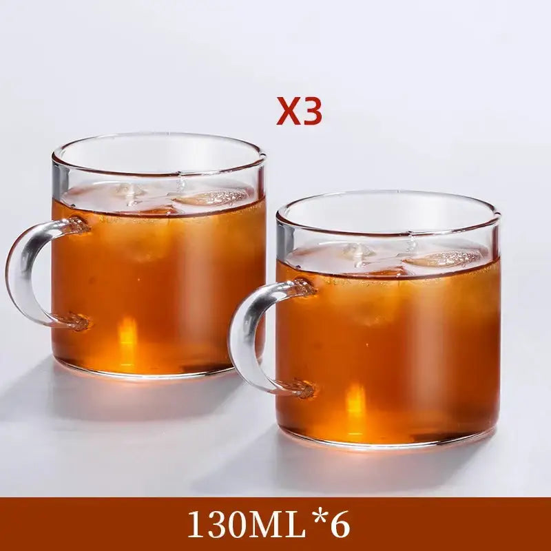 Modern heat resistant clear glass tea cup set with sturdy handles filled with iced tea for dining room use
