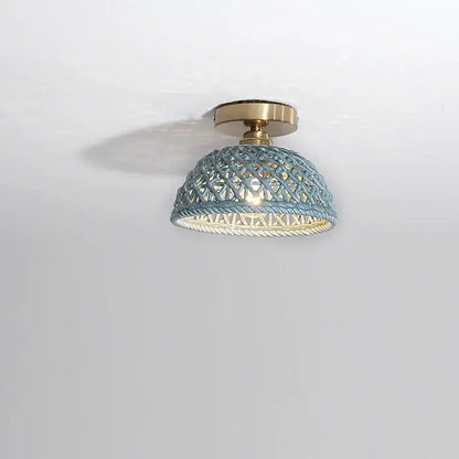A light blue woven rattan dome ceiling light with brass base complementing decorbites ceramic led ceiling lights