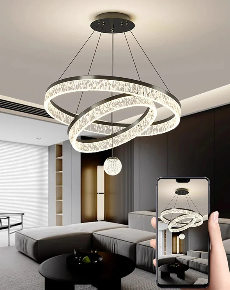 Modern black metal chandelier with three interlocking rings and sparkling crystal accents for living and dining rooms