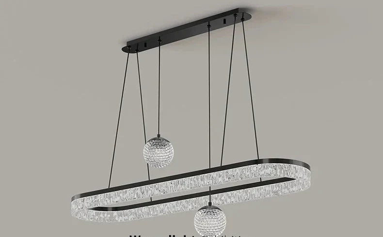 Modern black metal chandelier with oval frame and clear crystal beads featuring two spherical crystal pendants for living room lighting