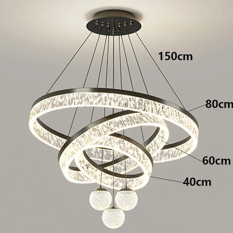 Modern black finished chandelier with three interlocking rings, sparkling crystals, and glass orbs for indoor lighting
