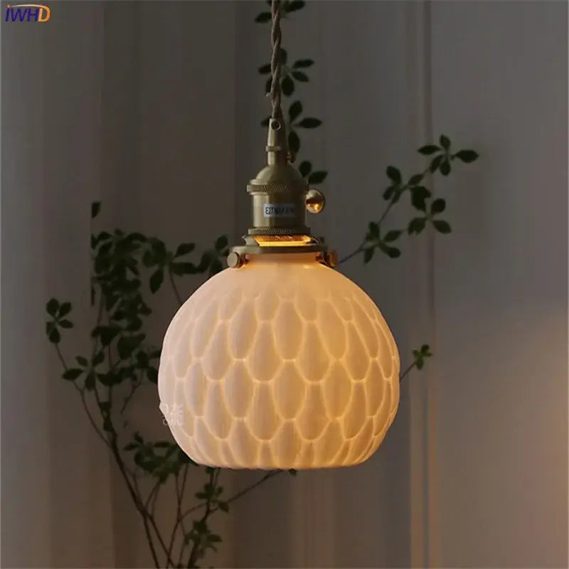 A warm cream ceramic led wall sconce with honeycomb texture and brass hardware for modern bedroom decorbites ceramic led