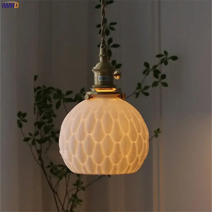 A warm cream ceramic led wall sconce with honeycomb texture and brass hardware for modern bedroom decorbites ceramic led