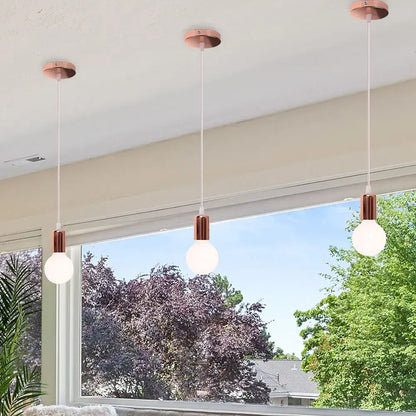 Three modern pendant lights with rose gold metal fixtures and white glass bulbs for decorbites cage pendant light
