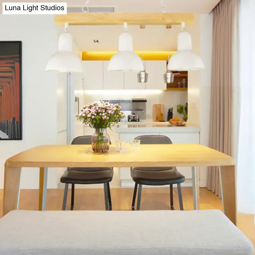 Decorbites™ modern black and white island light with wooden shade above light wood dining table with pink flowers