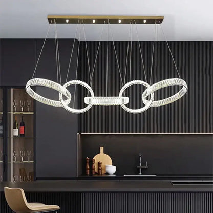 Modern gold-toned decorbites crystal chandelier pendant light featuring four interlocking crystal rings for ceiling lighting