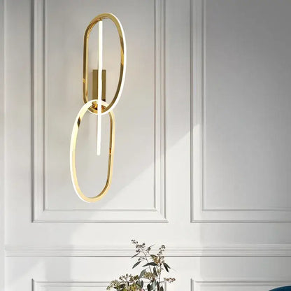 Modern interlocking oval gold wall sconce lighting fixture with two gold led rings for bedroom decorbites wall sconce