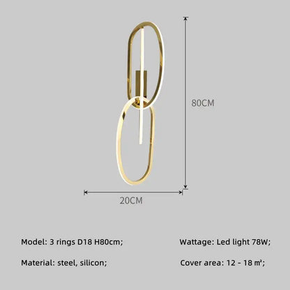 Gold-toned modern wall sconce lighting fixture with two interlocking oval rings and central led strip by decorbites gold led