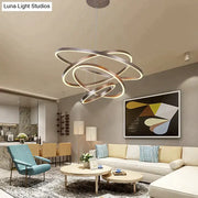 Modern pendant lights featuring metallic interlocking circular rings with warm led illumination for dining room