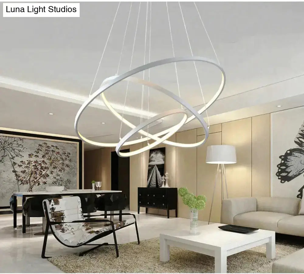 Modern white led pendant lights with interlocking circular rings designed for dining room lighting