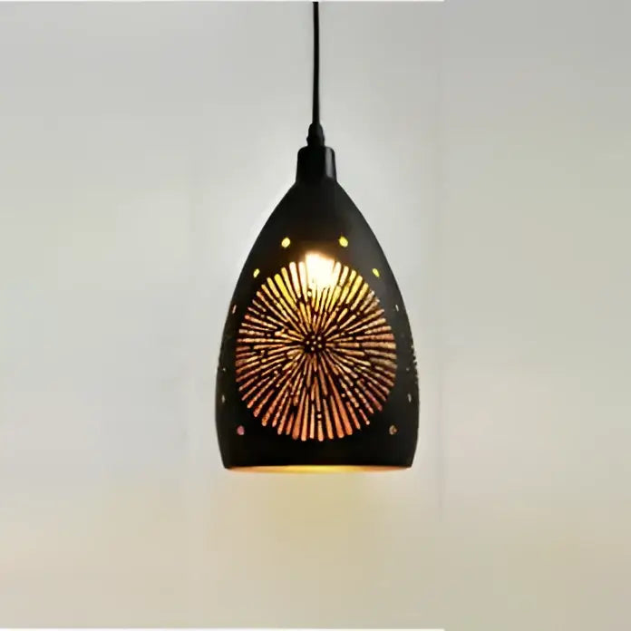 Modern iron cage pendant light featuring a black geometric sunburst cutout design emitting warm golden illumination
