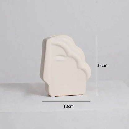 Cream-colored ceramic bookend with smooth abstract face design for modern irregular ceramic vase decorbites irregular ceramic