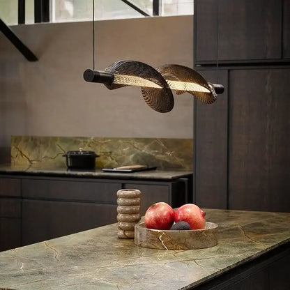 A modern italian style pendant light with twisted woven metal design and warm golden illumination for kitchen decorbites italian style