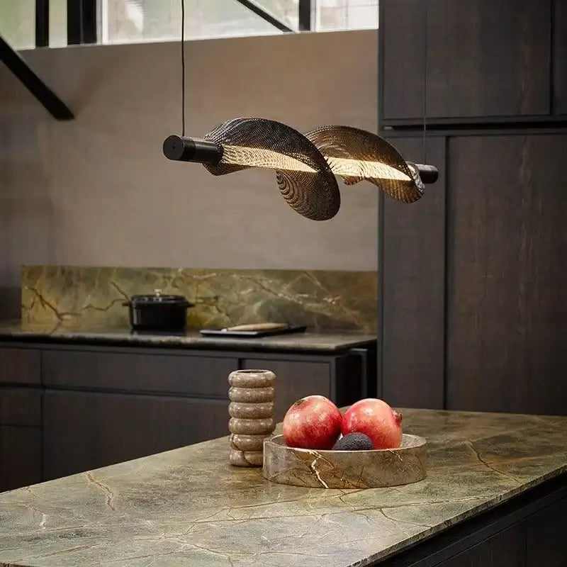 A modern italian style pendant light with twisted woven metal design and warm golden illumination for kitchen decorbites italian style