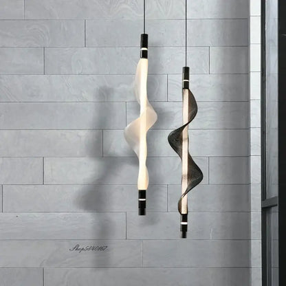 Two modern decorbites italian style pendant lights in translucent white and dark mesh hang against gray tiles