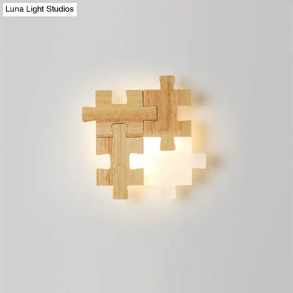 Modern jigsaw wood wall lamp featuring warm led lighting and a light-colored wooden puzzle piece sconce light