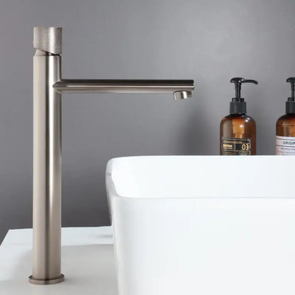 Modern knurled brushed gold basin faucet with a textured cylindrical handle and sleek brushed gold decorbites design