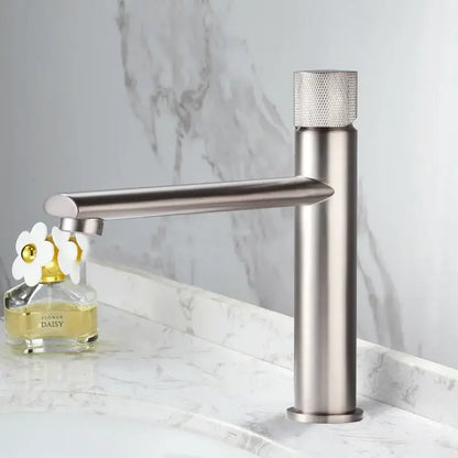 Modern knurled brushed gold basin faucet with a single-handle brushed stainless steel body and textured diamond knob by decorbites