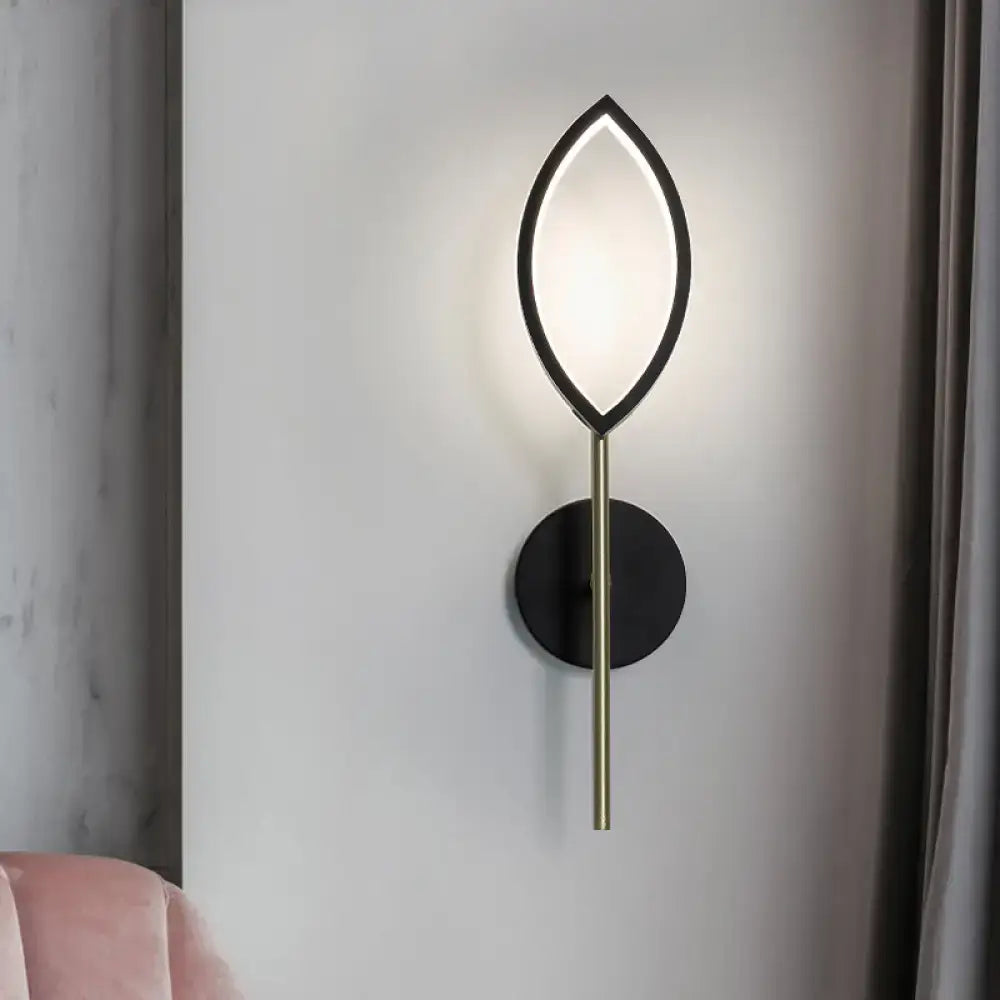 Modern leaf-shaped wall light with black frame and gold finish brass stem for living room use