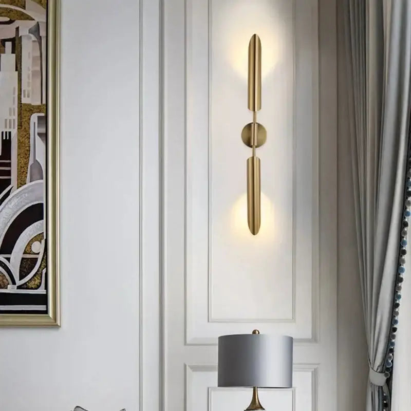 Modern leaf gold led wall lamp featuring gold-toned cylindrical arms and glass bulb for warm bedroom decorbites gold led lighting