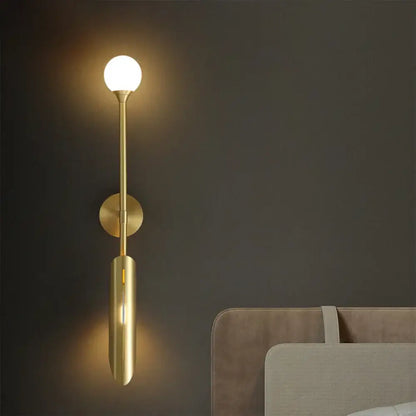 Modern leaf gold led wall lamp with gold-toned cylindrical stem and spherical glass bulb for bedroom decorbites gold led wall lamp