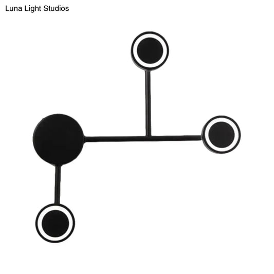 Modern led black wall sconce coat rack with four circular warm white hooks mounted on a minimalist black wall