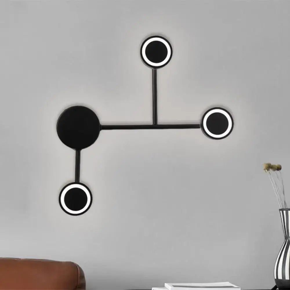 Modern led black wall sconce with circular led elements and warm white light for bedroom coat rack use