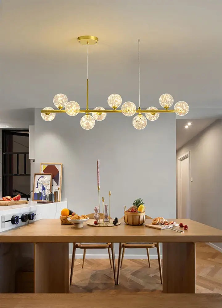 Gold-toned modern chandelier with frosted glass globe bulbs and a head ring design in the DecorBites™ 9-Light LED chandelier