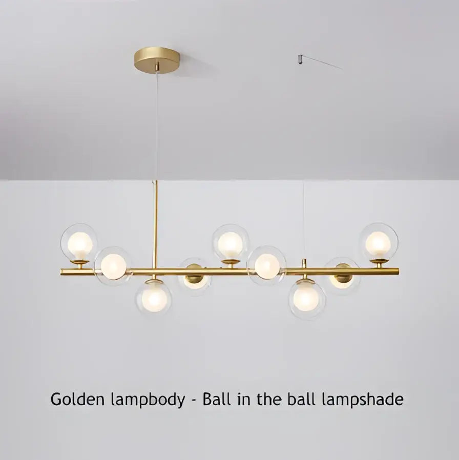 Golden pendant light with spherical glass lampshades and polished brass rod in a modern chandelier decorbites™ 9-light design
