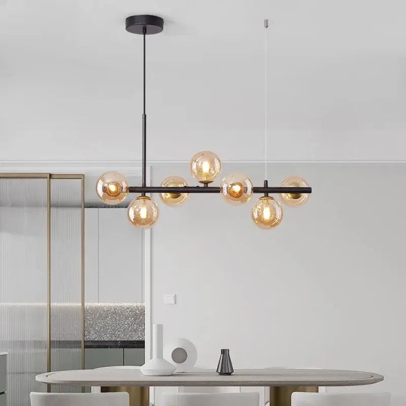 Modern black metal chandelier with six amber glass globe bulbs featuring a head ring design by DecorBites™