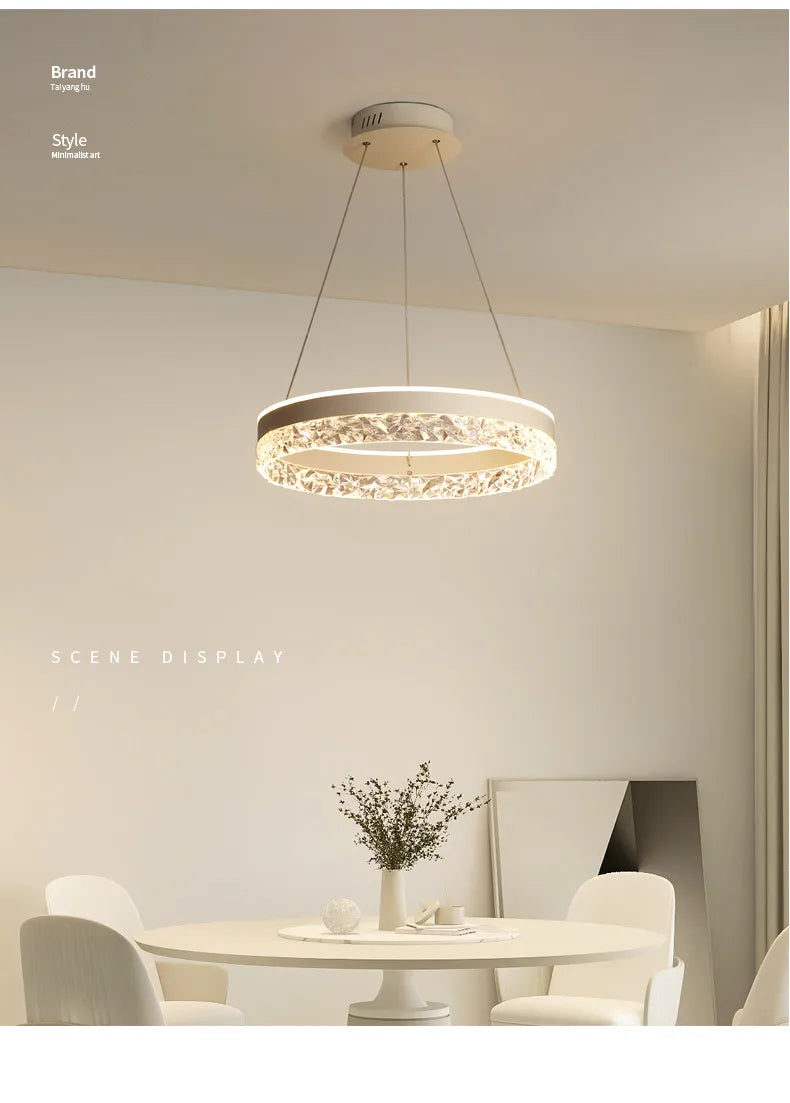 Modern led chandelier with a sleek white frame and crystal accents suspended by metallic cords for living room lighting