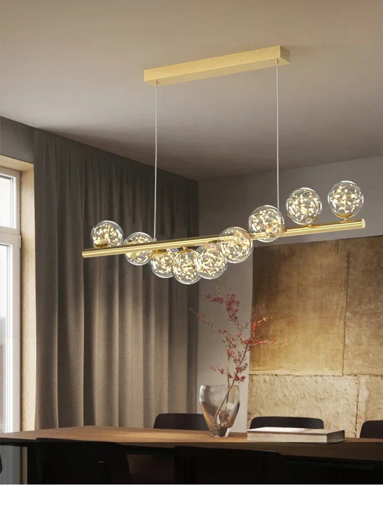 Gold-toned modern led ceiling chandelier with sleek horizontal bar and clear glass globe bulbs for dining room decor