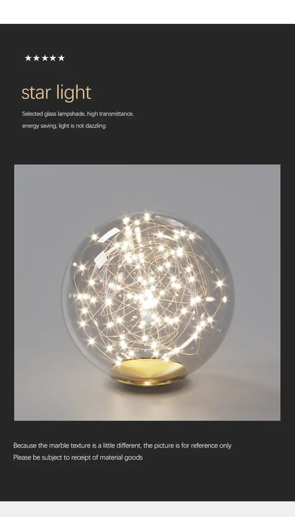 Modern led ceiling chandelier with clear glass spherical lamps and golden base illuminated by warm white led lights
